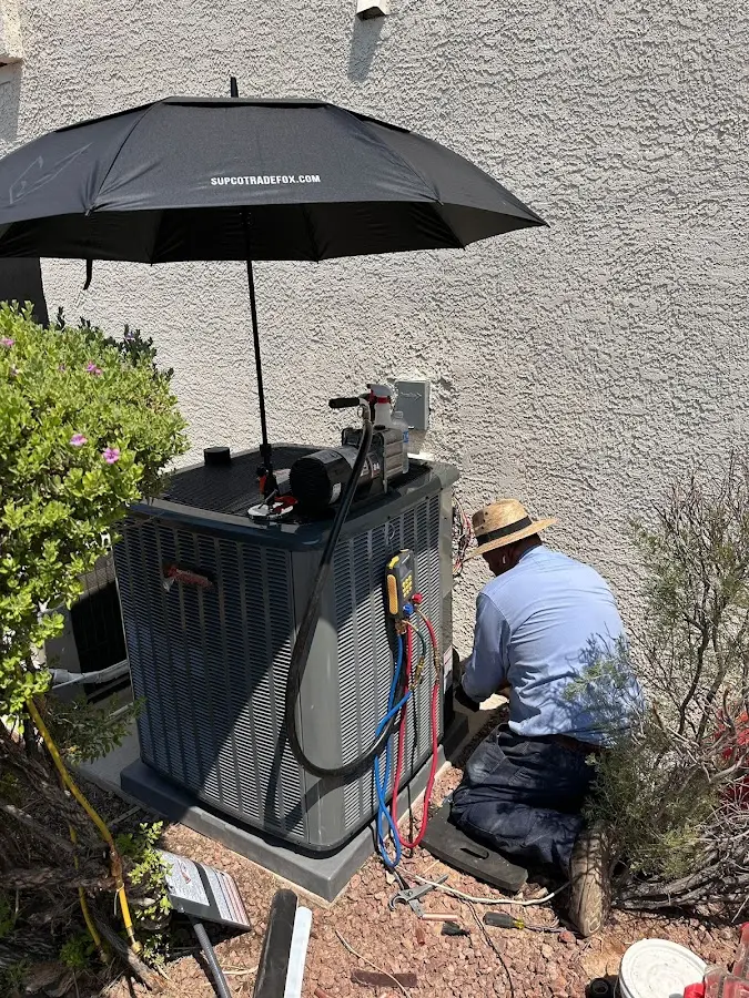 HVAC technician performing outdoor AC maintenance in Wappinger